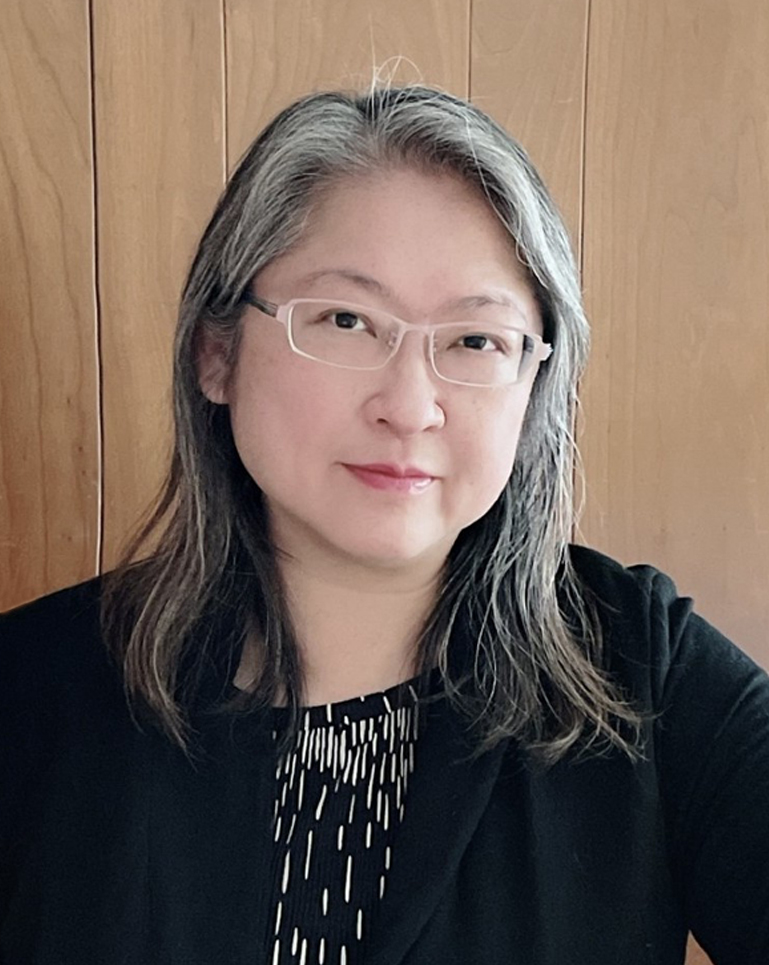 Portrait of a woman with glasses and a sweater
